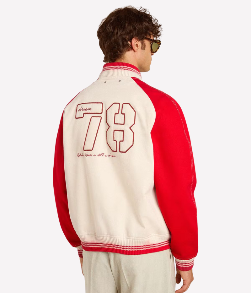 Golden Goose bomber jacket in worn white and red cotton with ‘Golden Club’ chest embroidery, faded striped ribbed trims, and double star on the back.
