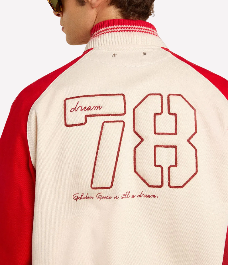 Golden Goose bomber jacket in worn white and red cotton with ‘Golden Club’ chest embroidery, faded striped ribbed trims, and double star on the back.
