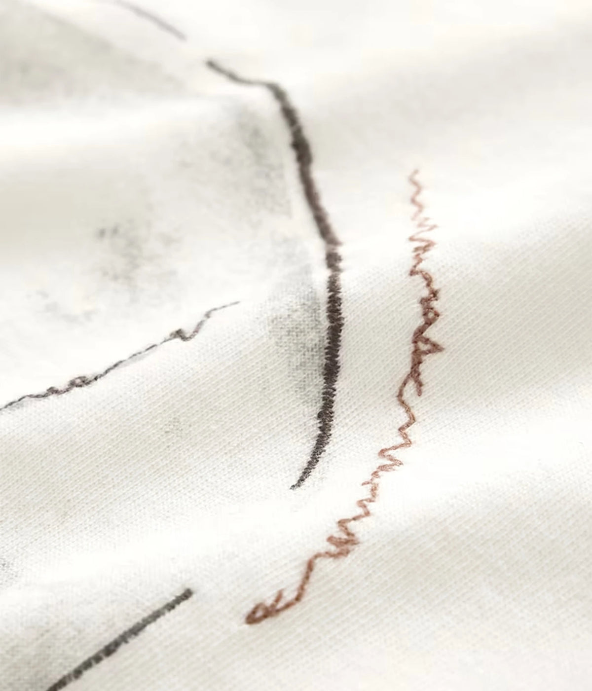 Close-up of John Varvatos Skull Embroidery Raw Edge Tee in Salt showing the embroidery detail