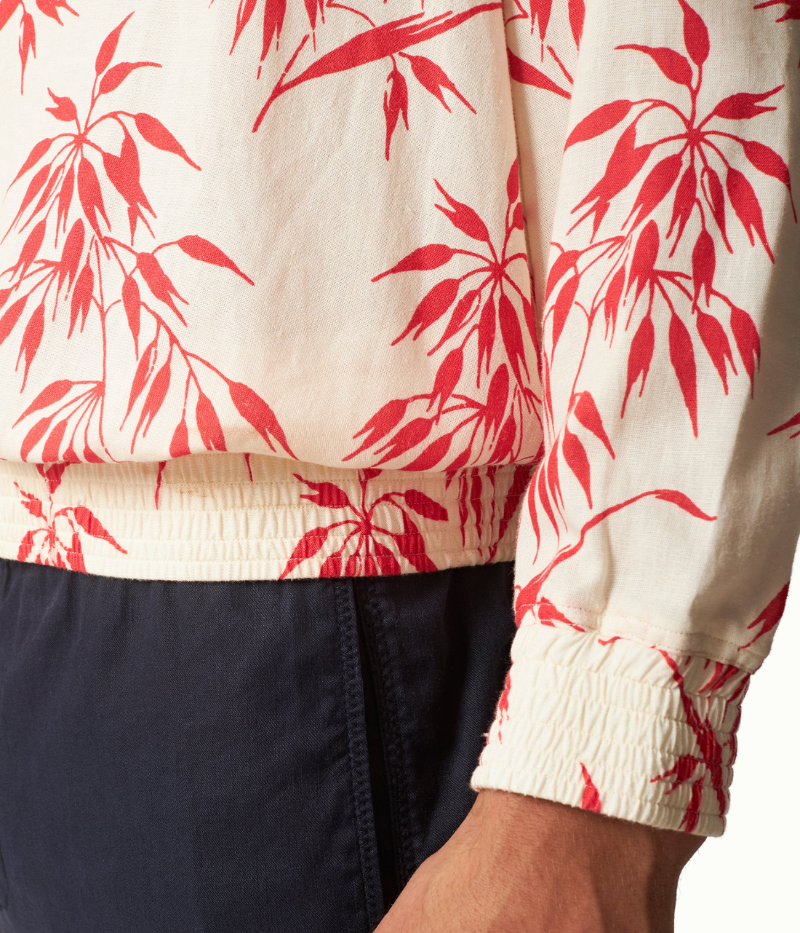 Lakewood long-sleeve overhead shirt in printed linen with red bamboo design, featuring concealed placket, classic collar, pleated back yoke for ease of movement, and branded imitation mother of pearl buttons.