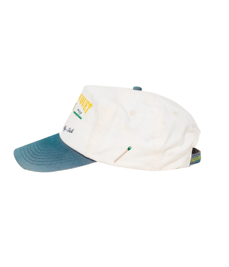 Nick Fouquet anchor crest cap – natural/blue potassium-sprayed canvas with embroidered anchor on front and "Oceania Kalypso" on strap.