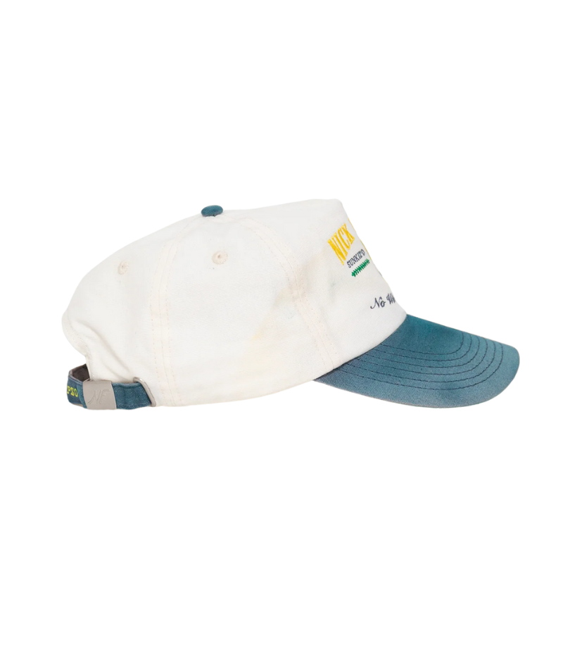 Nick Fouquet anchor crest cap – natural/blue potassium-sprayed canvas with embroidered anchor on front and "Oceania Kalypso" on strap.