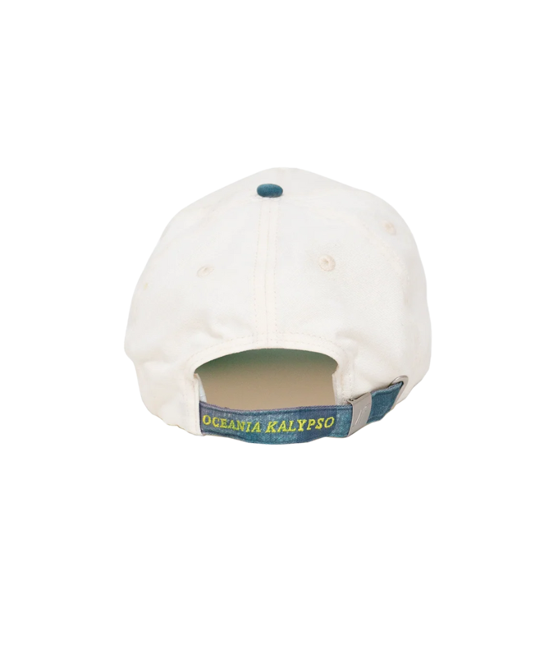 Nick Fouquet anchor crest cap – natural/blue potassium-sprayed canvas with embroidered anchor on front and "Oceania Kalypso" on strap.