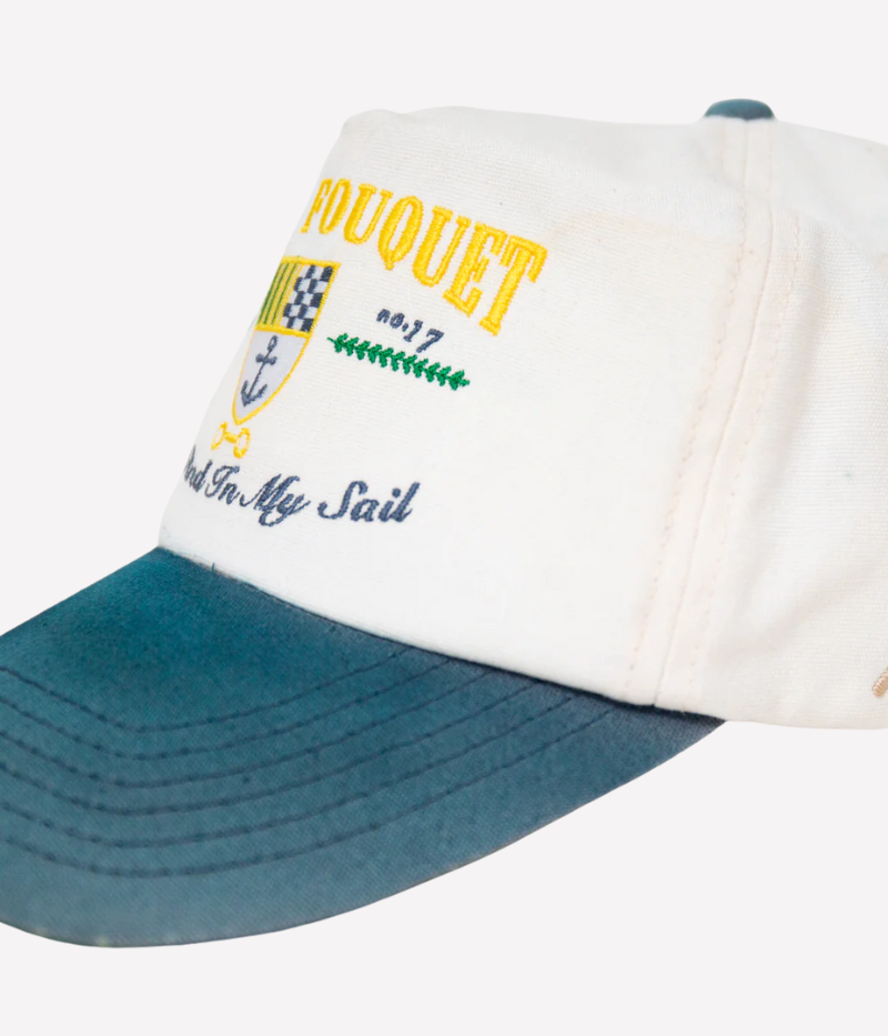 Nick Fouquet anchor crest cap – natural/blue potassium-sprayed canvas with embroidered anchor on front and "Oceania Kalypso" on strap.