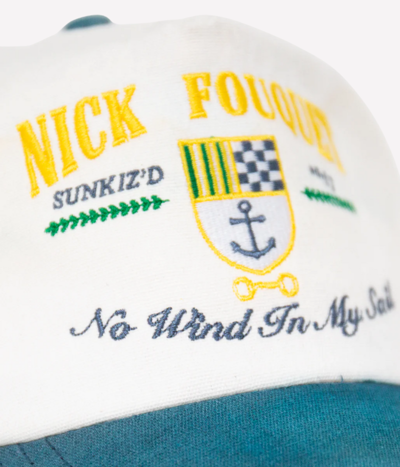 Nick Fouquet anchor crest cap – natural/blue potassium-sprayed canvas with embroidered anchor on front and "Oceania Kalypso" on strap.
