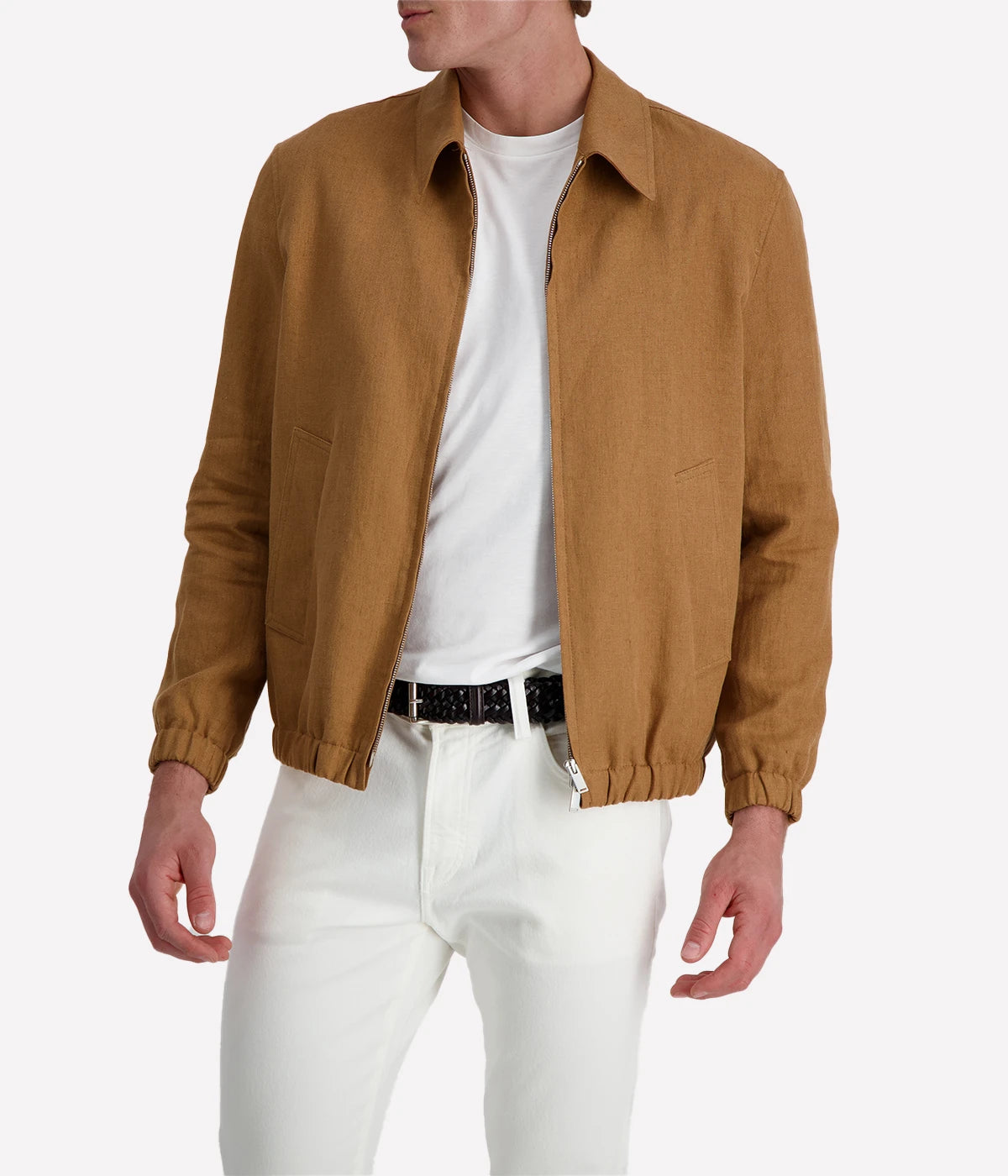 Man wearing a tan Lardini linen jacket with a zip front, elasticated hem and cuffs, and a shirt collar, styled with a white tee and white trousers.