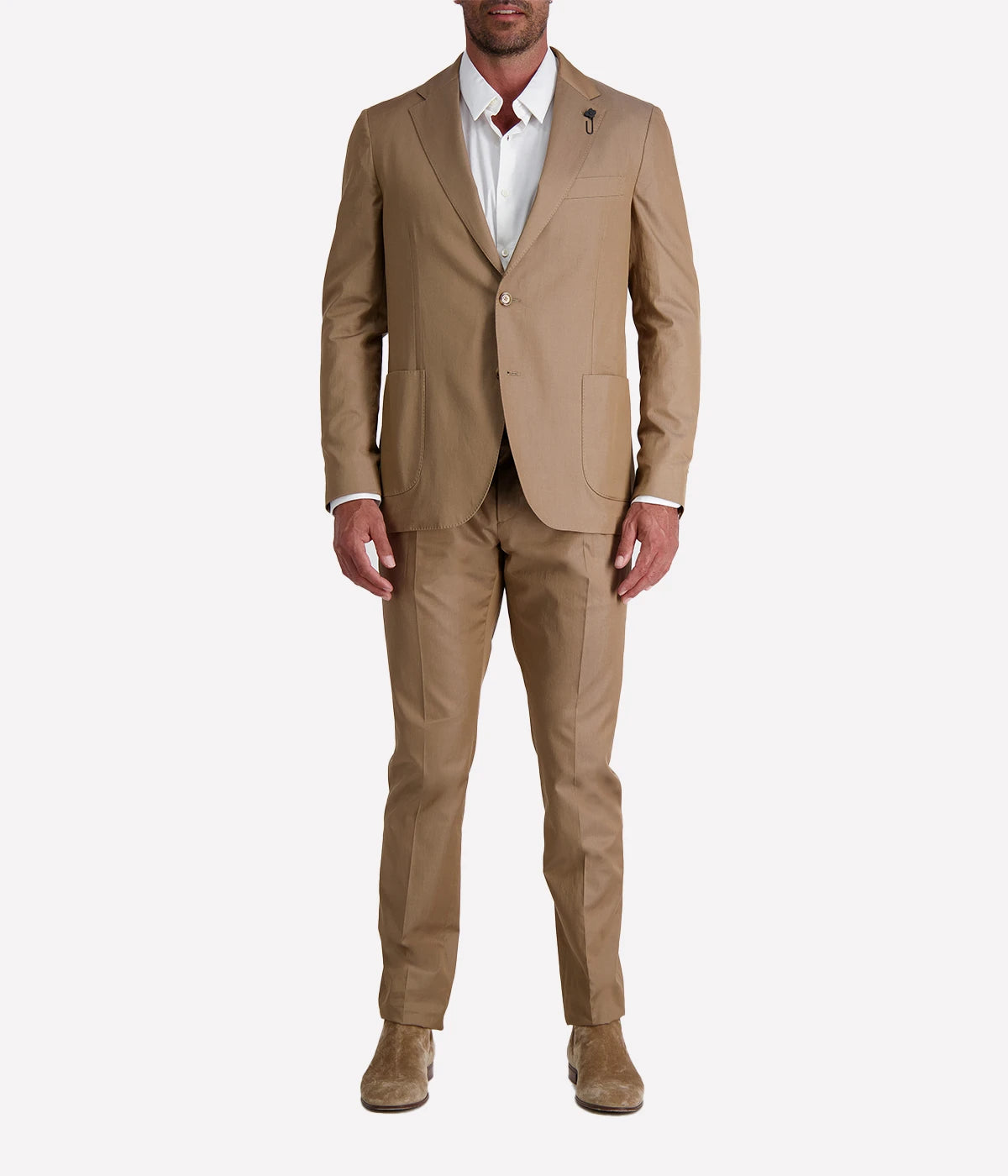 Model wearing a light brown Lardini cotton suit with a white shirt and suede loafers, featuring a single-breasted blazer with Lardini’s signature boutonnière, styled outdoors in a relaxed, modern setting.