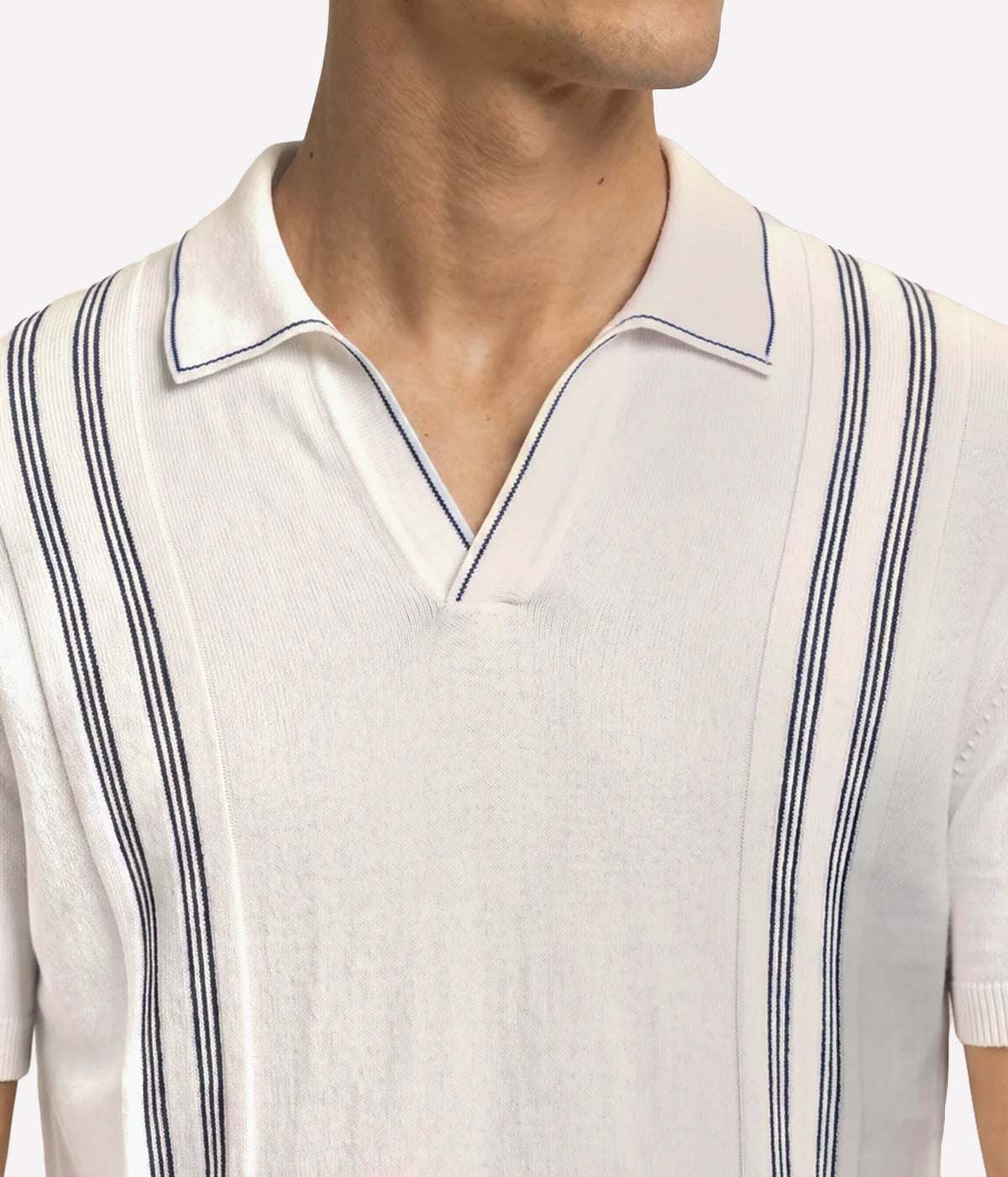 Close-up of Orlebar Brown Horton Chevron Stripe Polo in White Sand & Night Iris on model showing the chevron stripe front panel