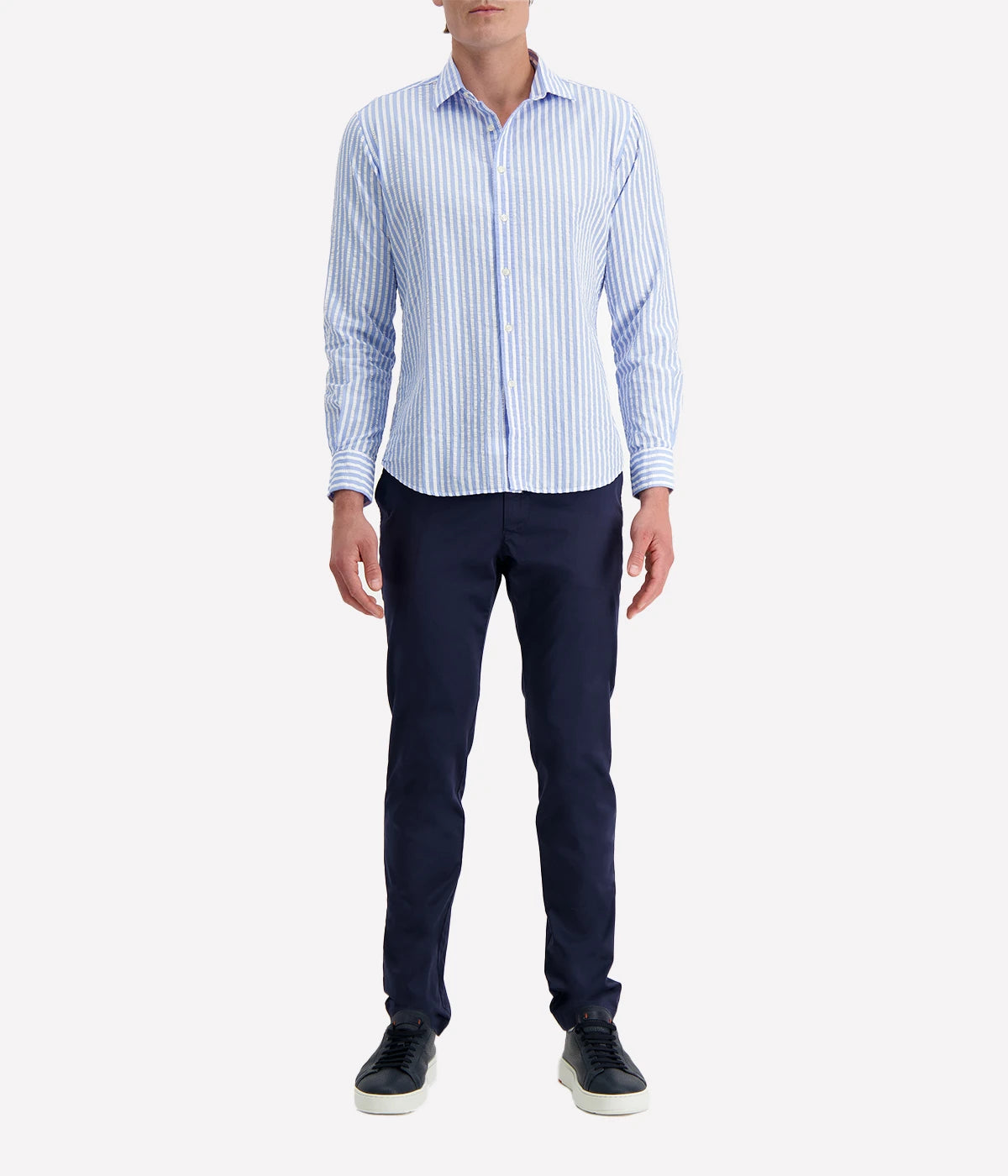 A men's slim-fit striped shirt by Ingram in lightweight blue and white cotton seersucker. Features a button-down front, a crisp collar, and long sleeves with buttoned cuffs. The breathable fabric has a subtle texture, perfect for a polished yet relaxed look.