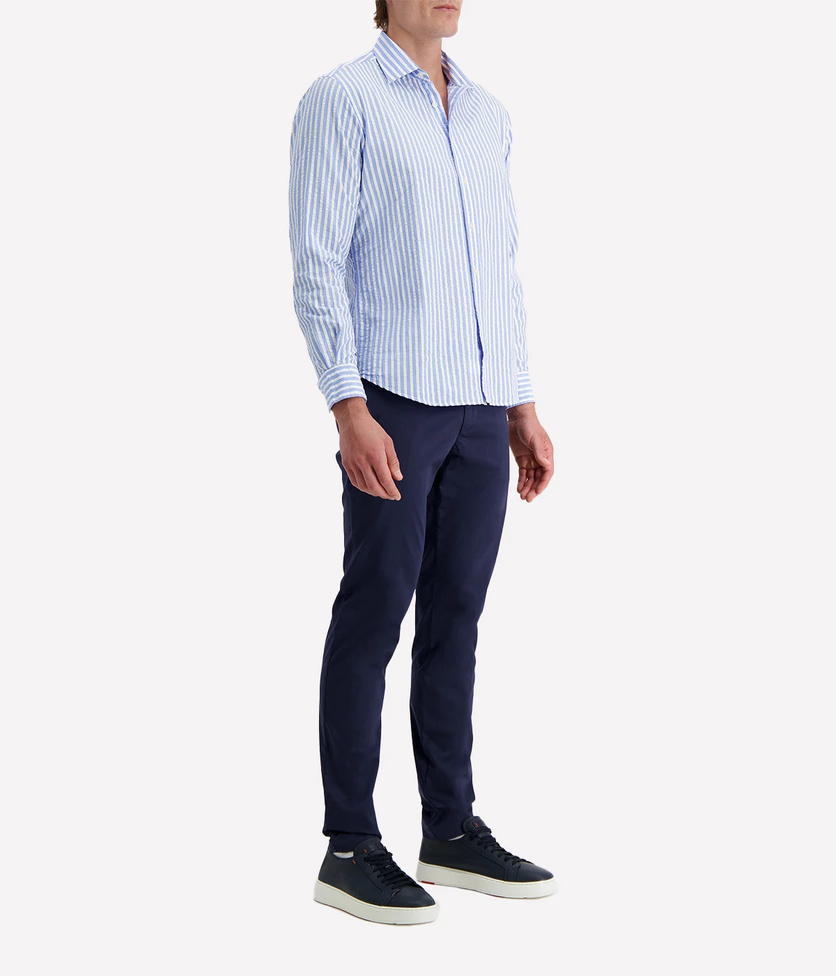 A men's slim-fit striped shirt by Ingram in lightweight blue and white cotton seersucker. Features a button-down front, a crisp collar, and long sleeves with buttoned cuffs. The breathable fabric has a subtle texture, perfect for a polished yet relaxed look.