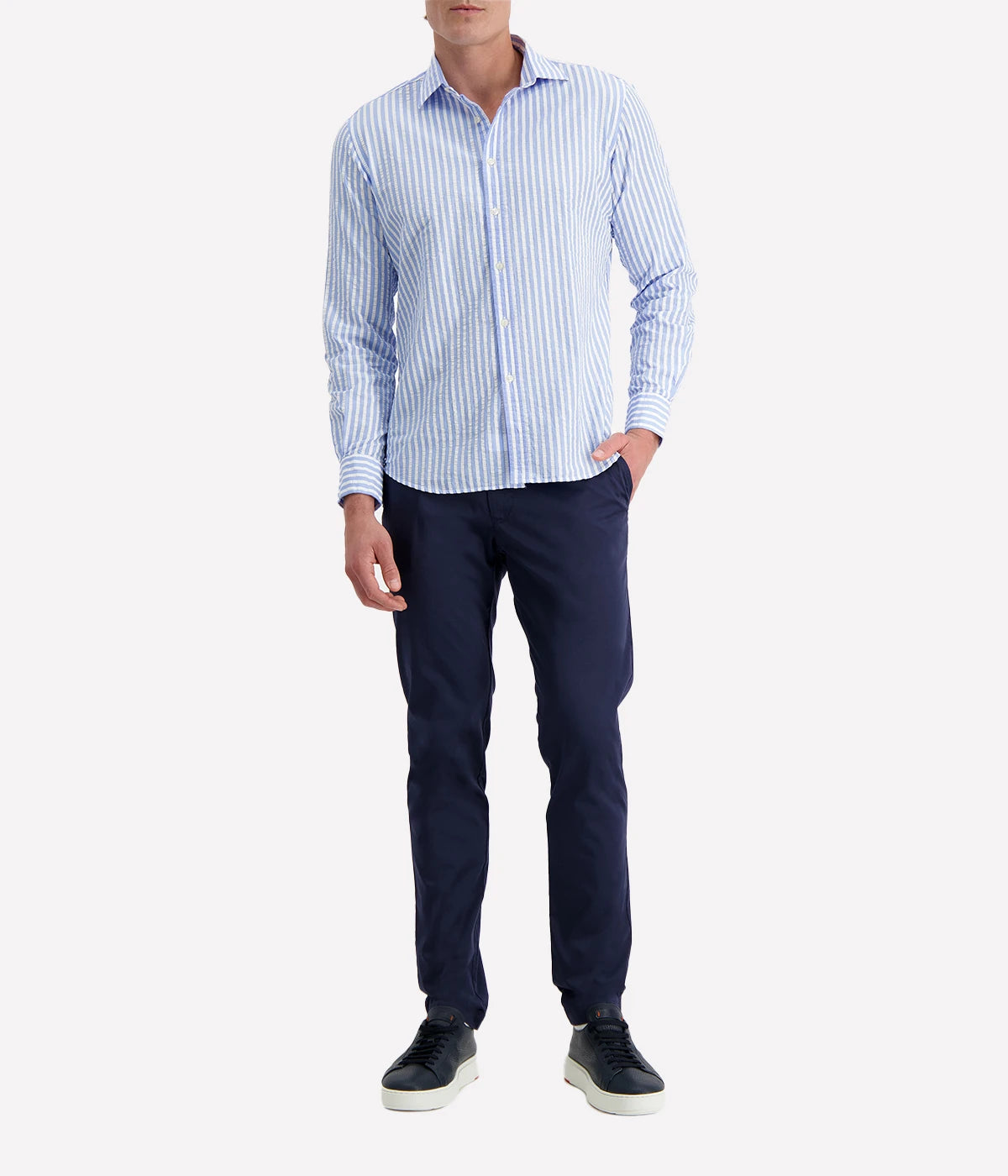 A men's slim-fit striped shirt by Ingram in lightweight blue and white cotton seersucker. Features a button-down front, a crisp collar, and long sleeves with buttoned cuffs. The breathable fabric has a subtle texture, perfect for a polished yet relaxed look.