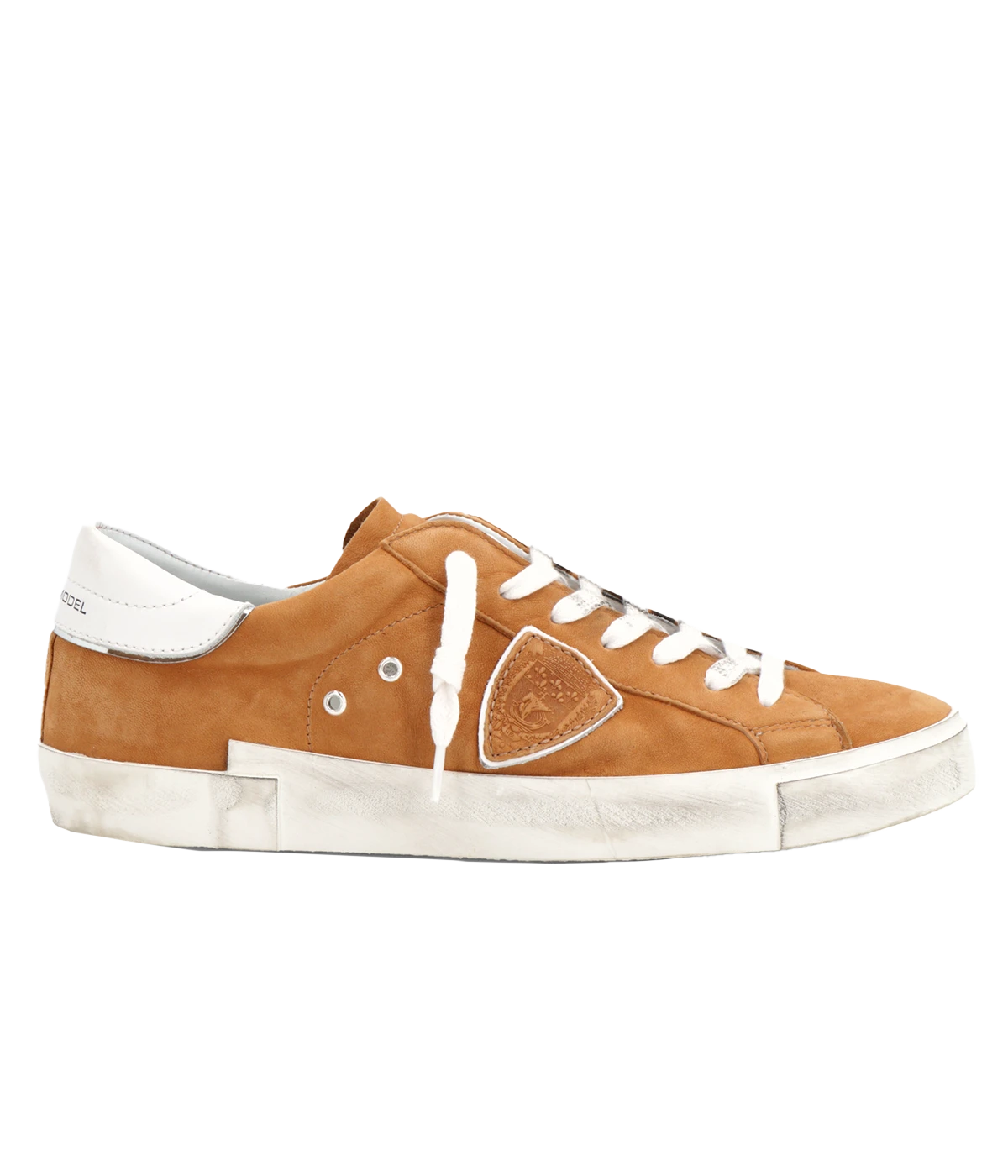 Side view of Philippe Model PRSX Low Man sneakers showcasing the unique vintage-effect design, with a patented foxing tape creating an imperfect sole. The shield on the side features the City of Paris coat of arms. The upper is crafted from high-quality Italian calfskin and suede, with laminated suede inserts.