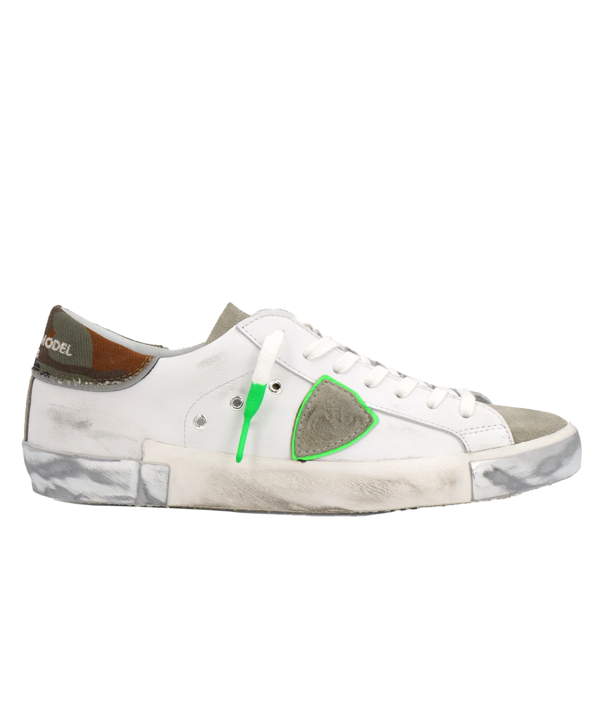 Side view of Philippe Model PRSX Low Man sneakers showcasing the unique vintage-effect design, with a patented foxing tape creating an imperfect sole. The shield on the side features the City of Paris coat of arms. The upper is crafted from high-quality Italian calfskin and suede, with laminated suede inserts.