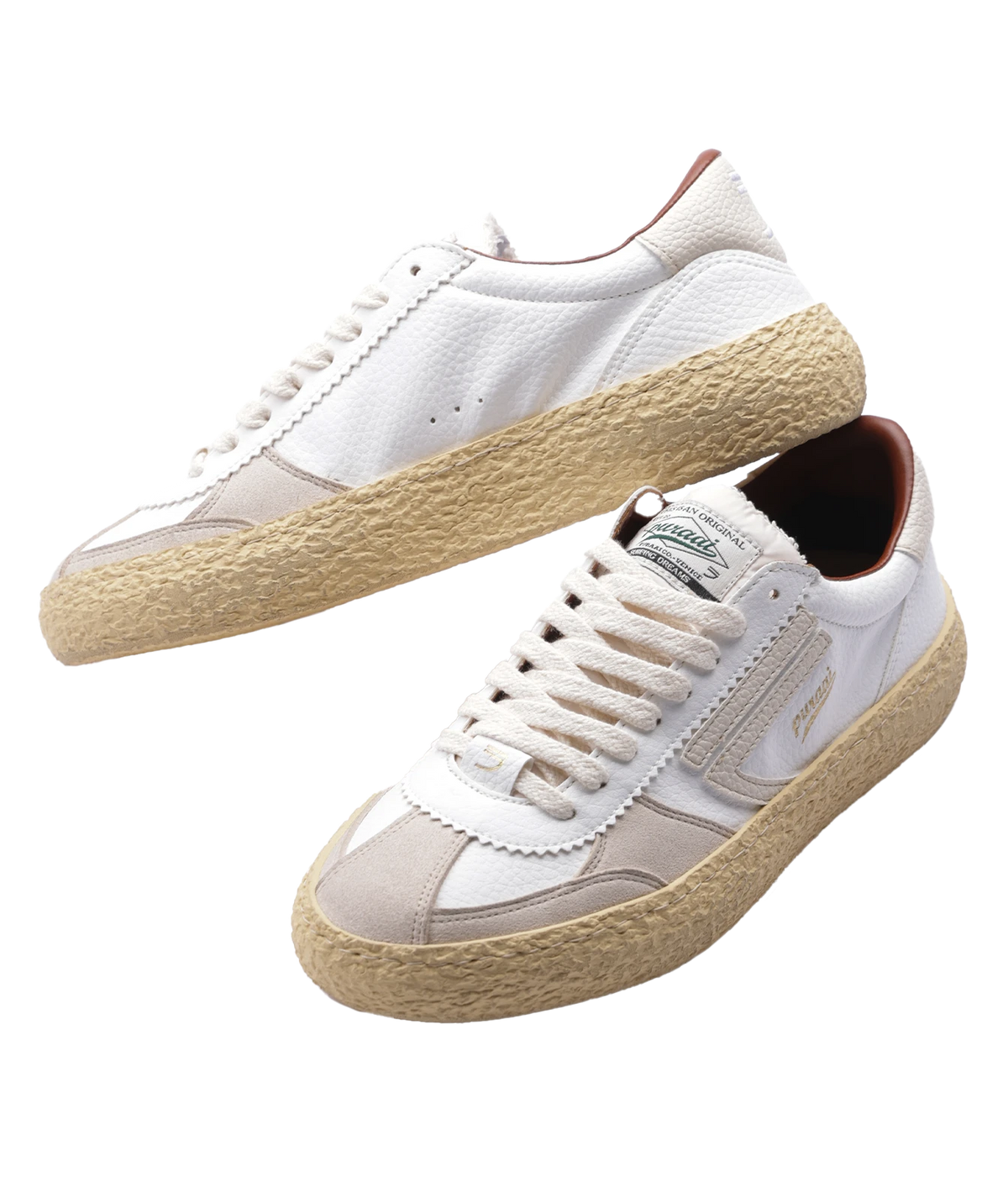 A pair of white sneakers with beige panels, cream laces, and thick natural jute soles, shown on a plain white background.