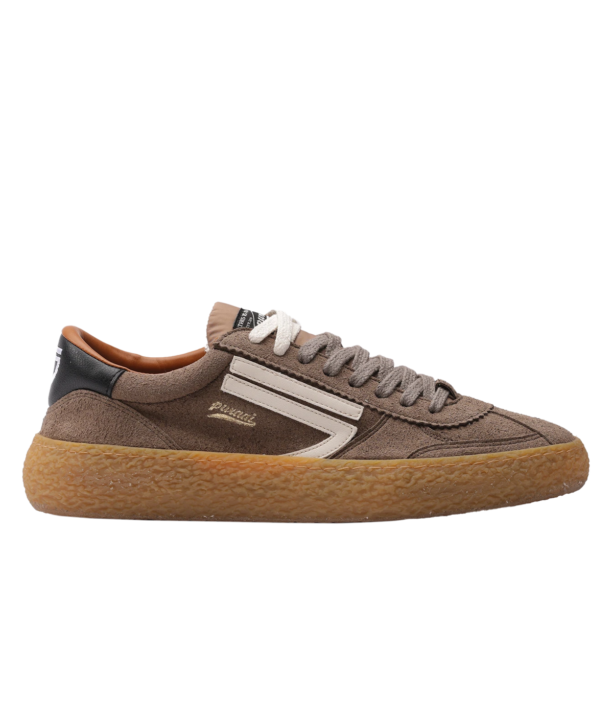 A brown sneaker with a textured gum rubber sole, featuring a white side stripe, white laces, and a black heel tab. The brand 'Puraai' is visible on the side of the shoe.