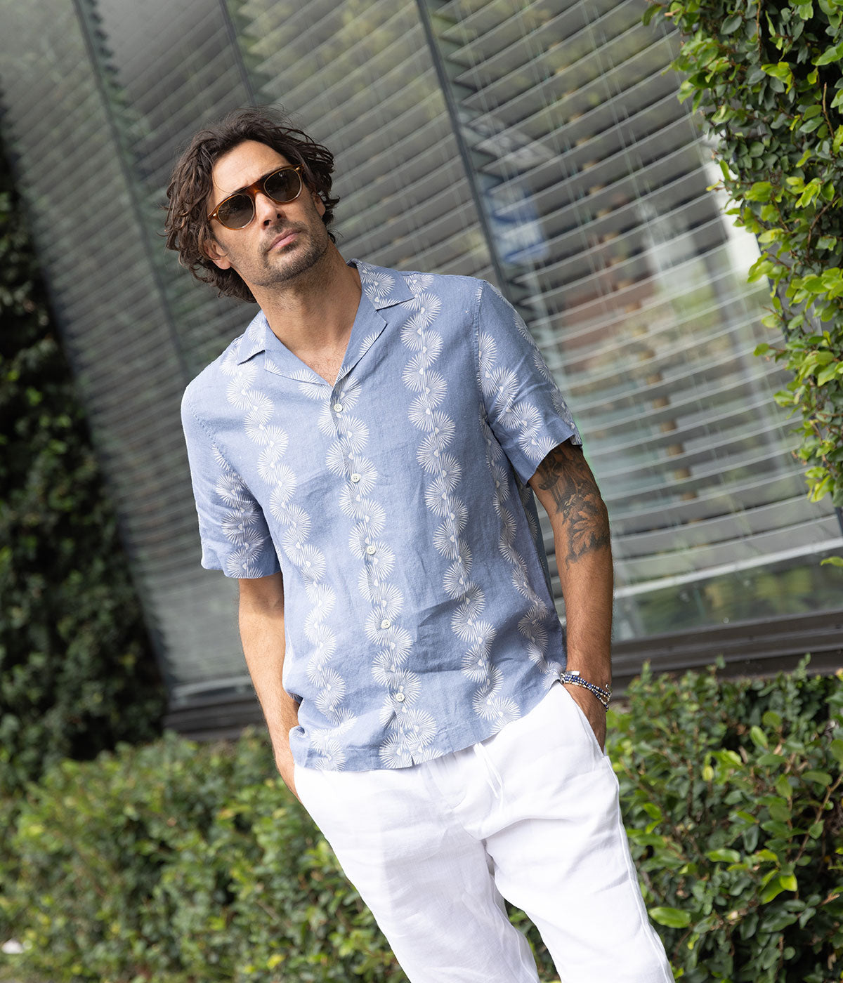 The Roberto Linen Short Sleeve Geo Shirt in Denim Blue features a modern geometric pattern and lightweight linen fabric. With a relaxed fit and short sleeves, this shirt is perfect for warm weather, offering breathability and versatility for casual or dressier occasions.
