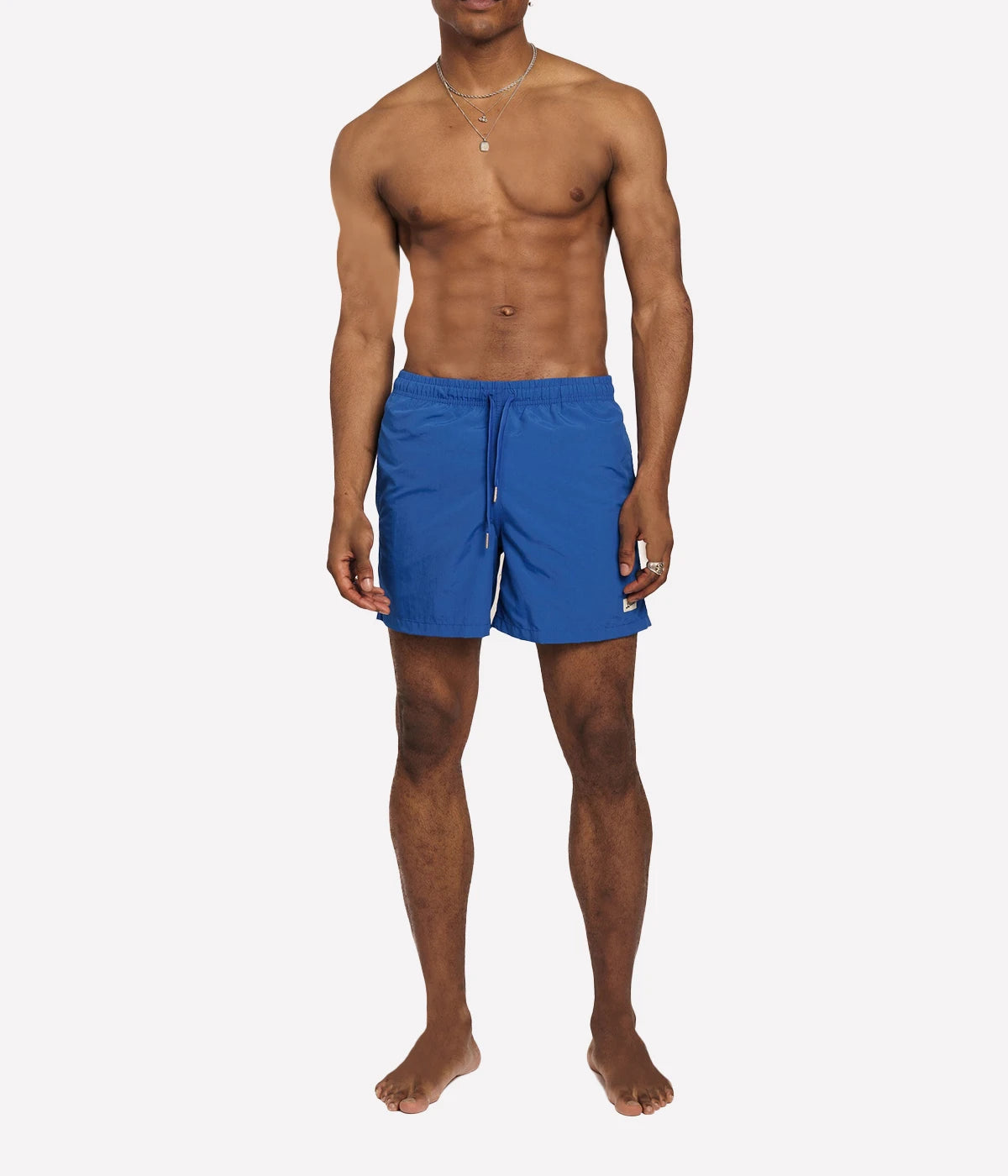 Model wearing Bather solid swim trunks, highlighting the tailored fit and casual design. The quick-dry fabric and stretch mesh lining make these trunks ideal for swimming, lounging, or outdoor activities.