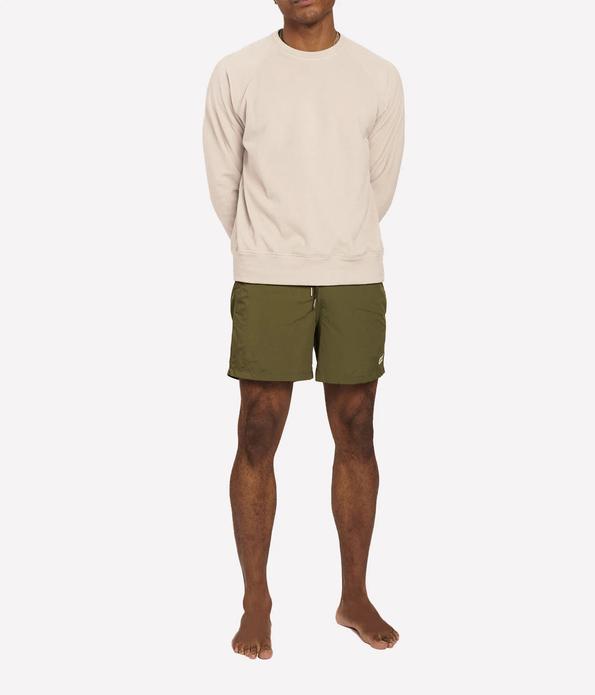 Model wearing Bather solid swim trunks, highlighting the tailored fit and casual design. The quick-dry fabric and stretch mesh lining make these trunks ideal for swimming, lounging, or outdoor activities.