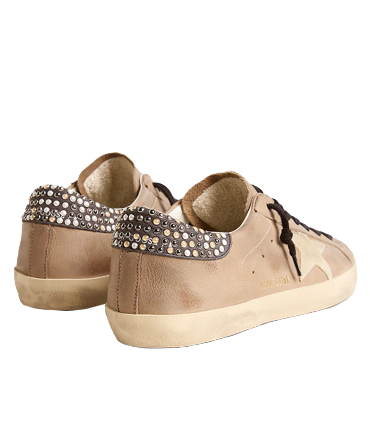 Rear view of Golden Goose sneakers, showing pearl studs on the heel tab, a soft leather lining, and a worn-in rubber sole for timeless style and comfort.