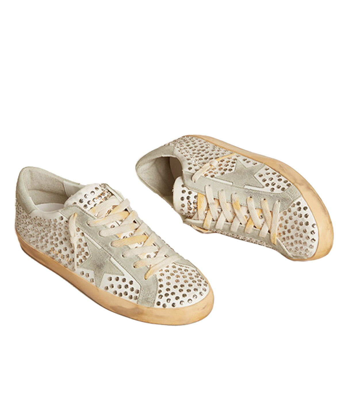The Golden Goose Super Star Sneakers feature a suede star and are designed with the brand’s signature distressed detailing, complemented by all-over flat studs. Embossed logo lettering on the outer side of the right shoe adds a unique touch. With a rubber sole and round toe, these sneakers offer a stylish yet comfortable fit, making them the perfect addition to elevate casual looks with an edgy, luxurious twist.