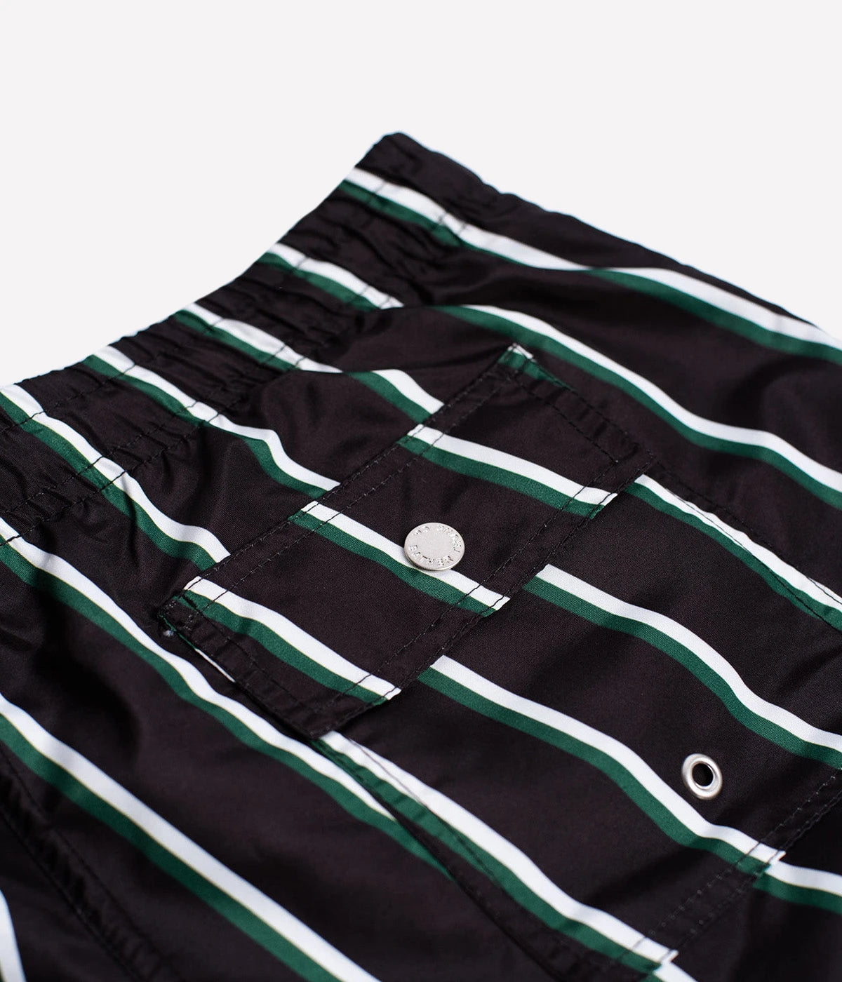 Close-up of Bather swim trunks’ fabric, showcasing the smooth, quick-dry 100% recycled polyester material. The ultra-fine mesh lining offers a soft, barely-there feel with four-way stretch for optimal mobility.