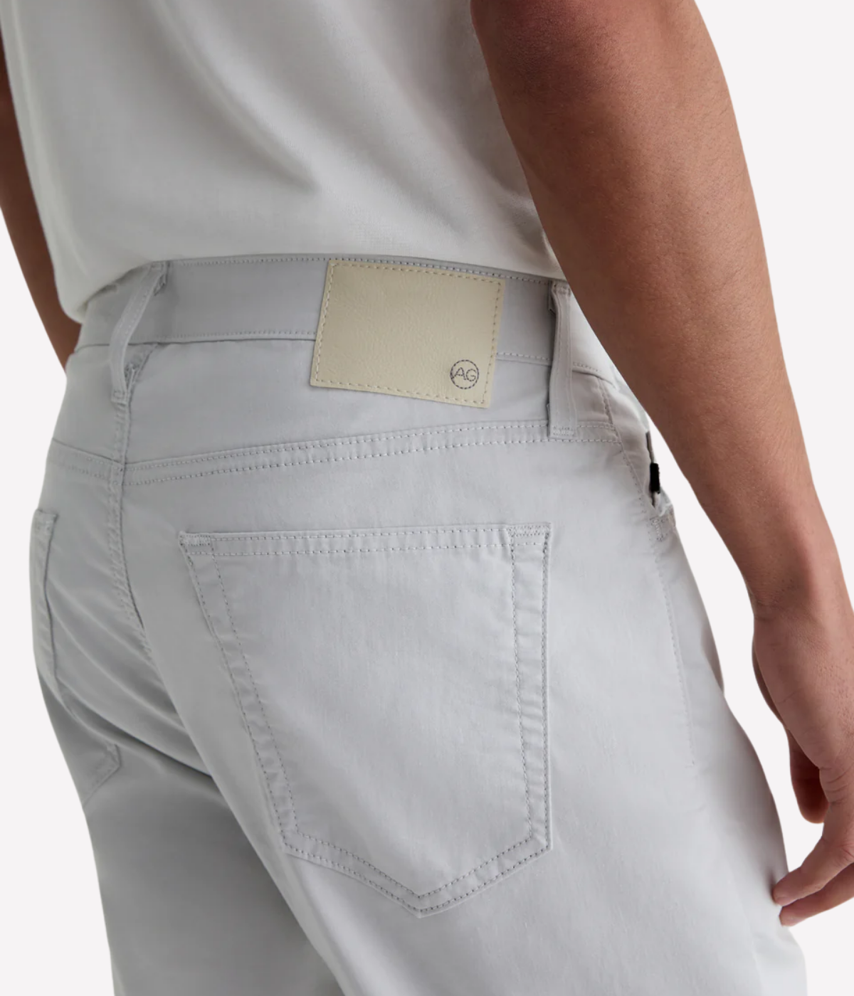 AG Tellis slim fit jeans in 'Almost White' Airluxe™ sateen—lightweight, breathable, and tailored with a tapered leg for modern comfort.
