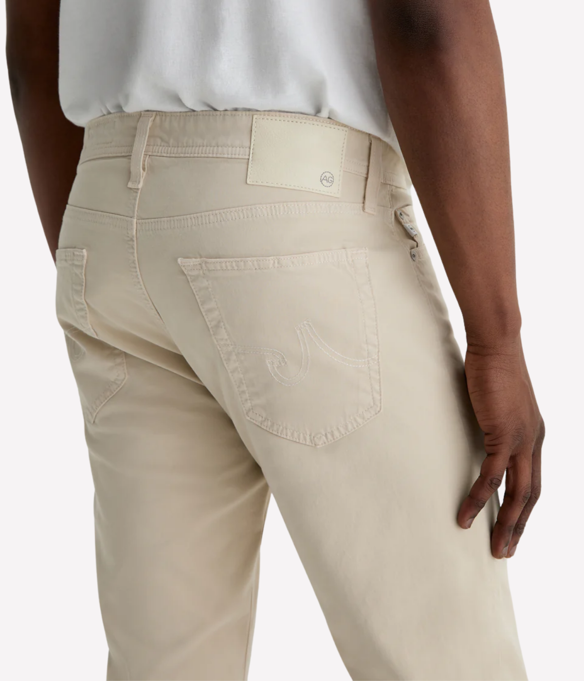 AG Tellis jeans in Natural Ivory, crafted from sueded stretch sateen with a slim fit, tapered leg, and soft brushed texture for elevated everyday wear.