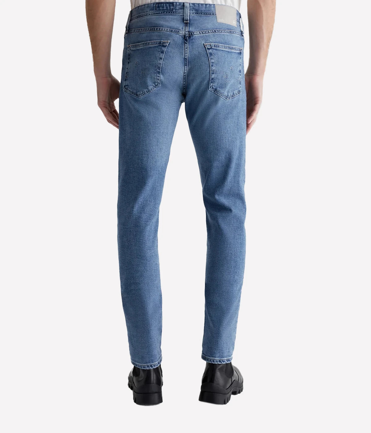 Men’s light blue slim jeans with fading, whiskering, and indigo seam variations.