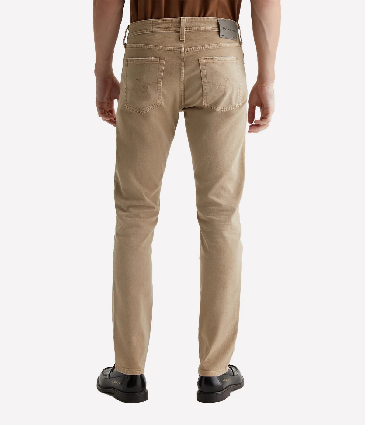Sulfur-dyed khaki slim jeans for men, featuring a 7-year fade effect. Designed with a fitted upper block and tapered leg openings in 8.7 oz. Hyper Soft Bull Denim. The velvety fabric, part of the AG Cloud Soft Denim™ collection, offers dual-elastic stretch and a supple feel that softens with wear.