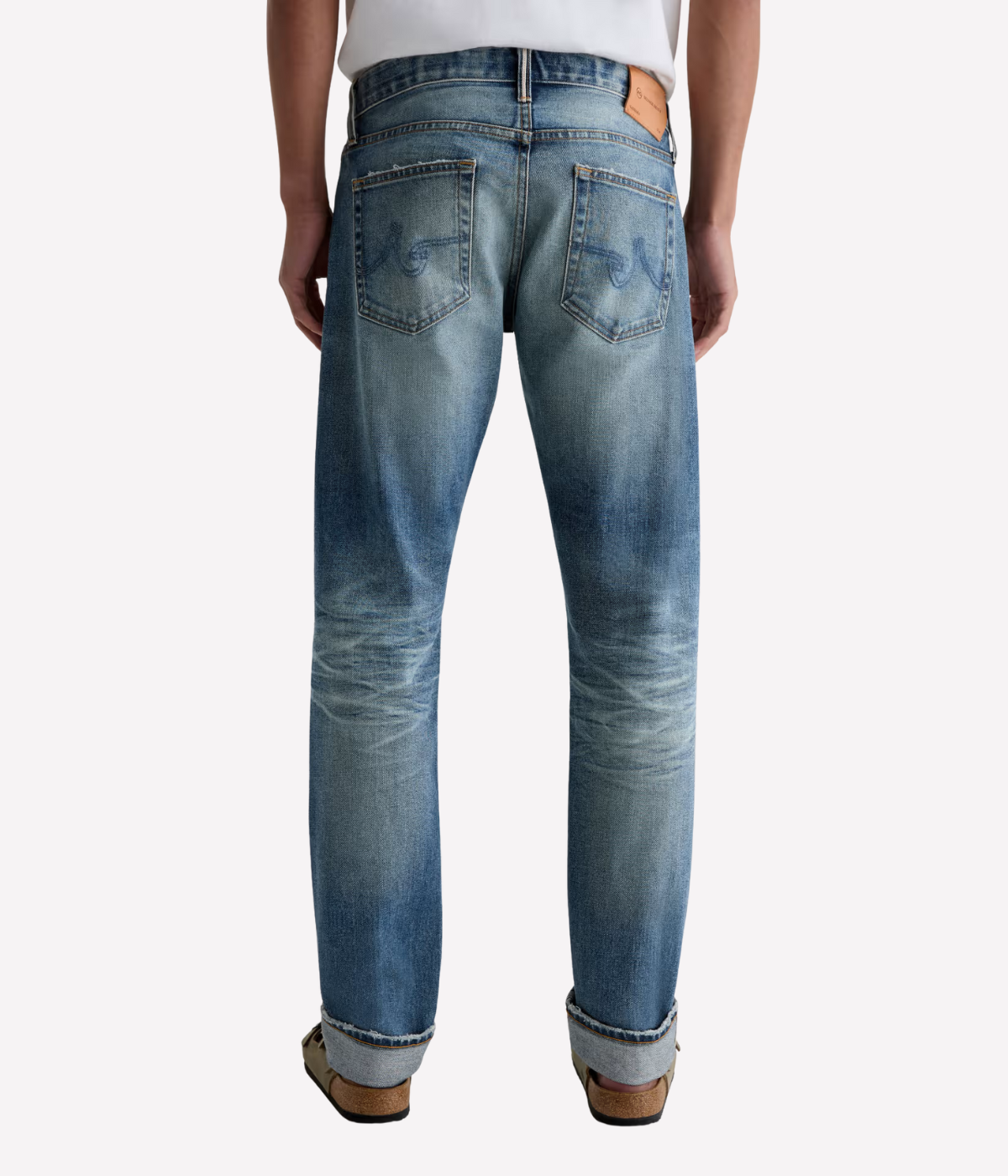 Men’s AG Tellis jeans in 14-year faded blue AG-ed™ wash, crafted from Japanese stretch selvage denim with a modern slim fit and tapered leg.