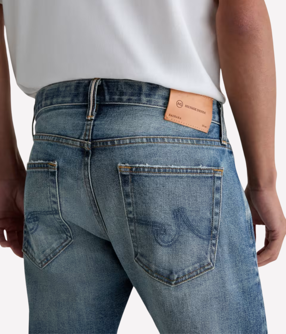 Men’s AG Tellis jeans in 14-year faded blue AG-ed™ wash, crafted from Japanese stretch selvage denim with a modern slim fit and tapered leg.