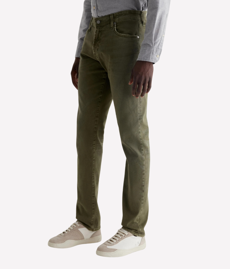 The Tellis jean in sulfur-dyed grass green features a modern slim fit with a mid-rise waist and tapered leg. Crafted from Hyper Soft Bull Denim with AG Cloud Soft Denim™ for a luxuriously soft feel and enhanced stretch.