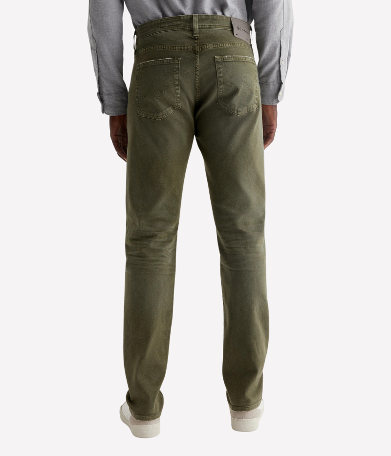 The Tellis jean in sulfur-dyed grass green features a modern slim fit with a mid-rise waist and tapered leg. Crafted from Hyper Soft Bull Denim with AG Cloud Soft Denim™ for a luxuriously soft feel and enhanced stretch.