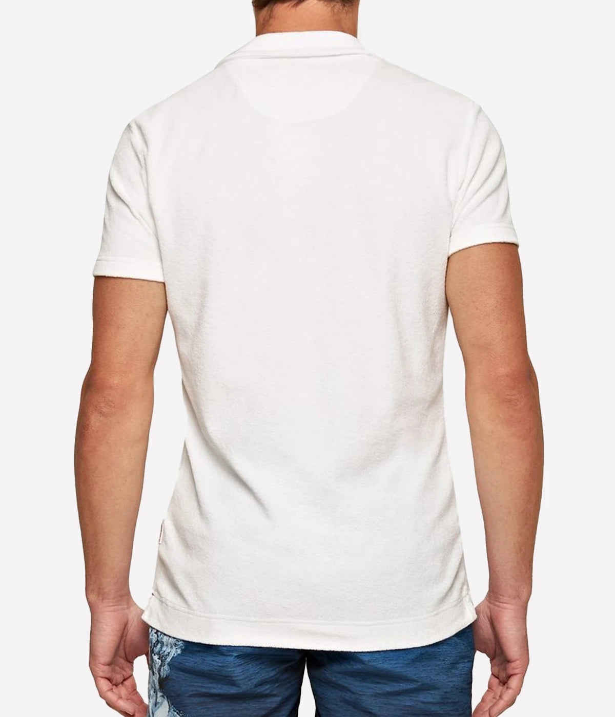 White terry towelling polo by Orlebar Brown, featuring a soft and breezy fabric with a stylish open placket. The tailored fit ensures comfort without being too snug, making it the perfect casual yet polished piece. Pair it with Orlebar Brown swim shorts for a complete holiday look. Made from 100% terry towelling cotton.