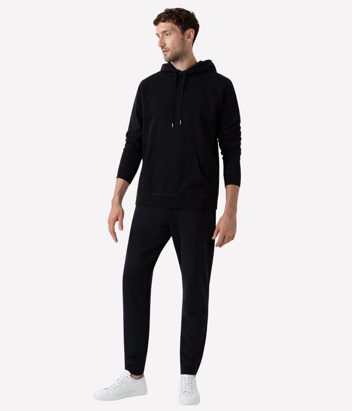 Men’s slim fit track pants in black, crafted from loopback cotton with ribbed waistband and tapered leg—part of a matching track set.