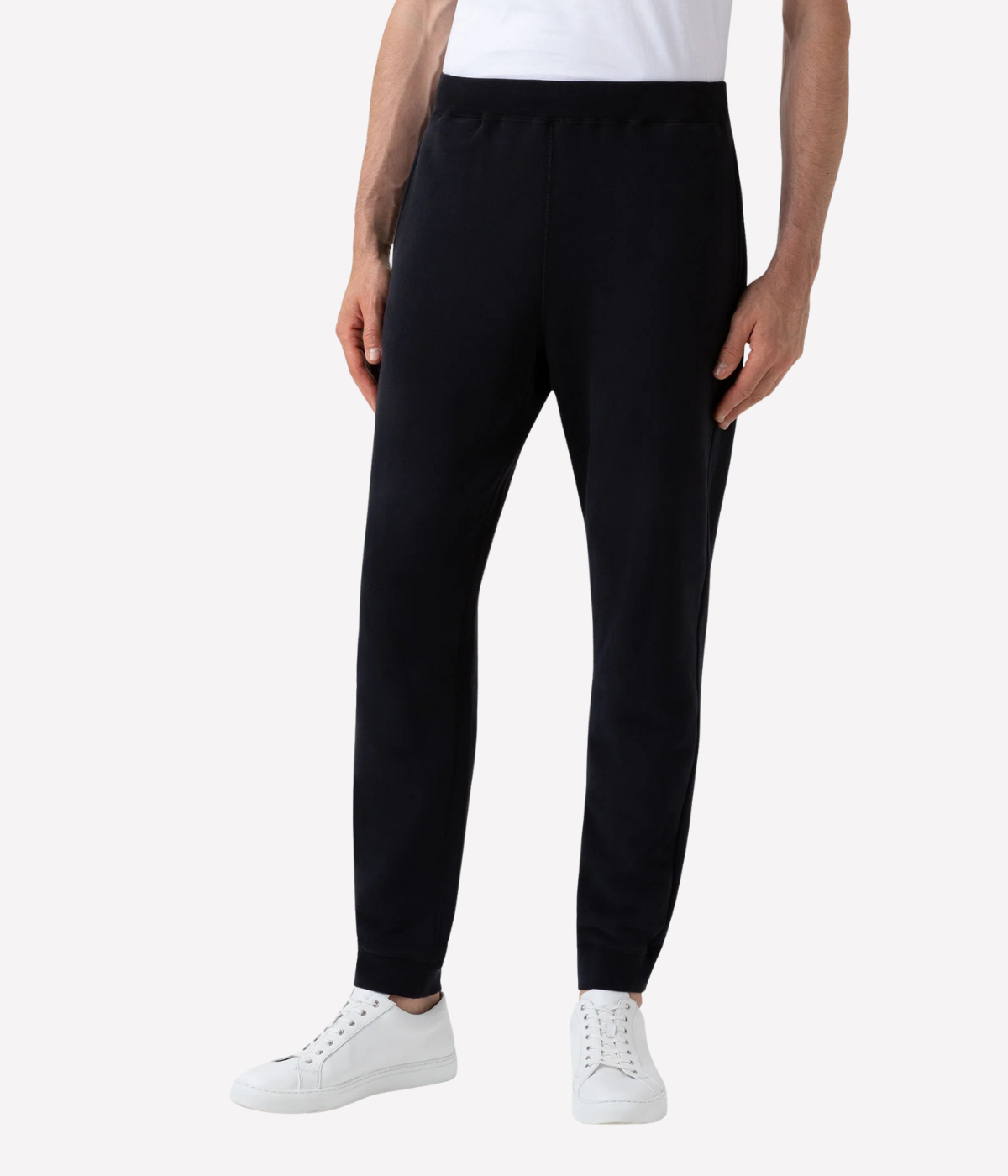 Men’s slim fit track pants in black, crafted from loopback cotton with ribbed waistband and tapered leg—part of a matching track set.
