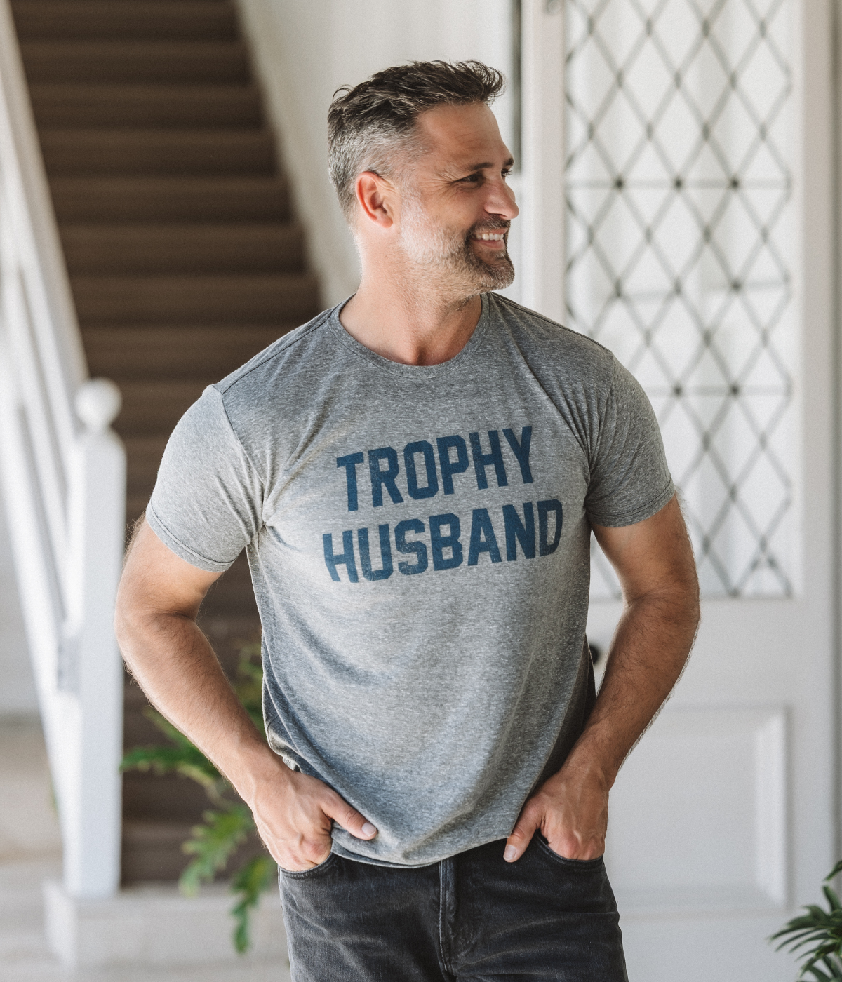 Men’s relaxed-fit “Trophy Husband” graphic tee in soft cotton-blend, playful casual wear.