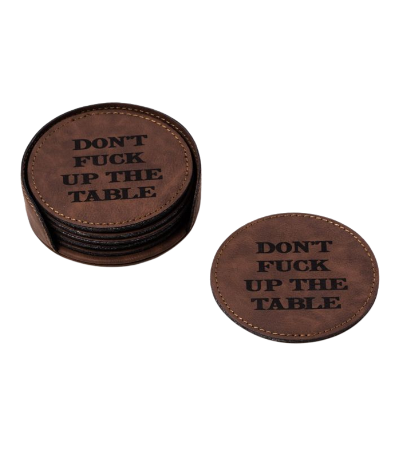 A set of six rustic brown coasters with tonal stitching, neatly stacked in a matching holder. Each coaster features bold laser-branded text adding a playful touch to any setting.