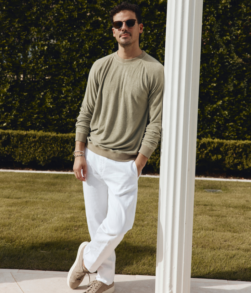 Men's regular-fit cotton-linen trousers with tab-button closure and welt pockets.
