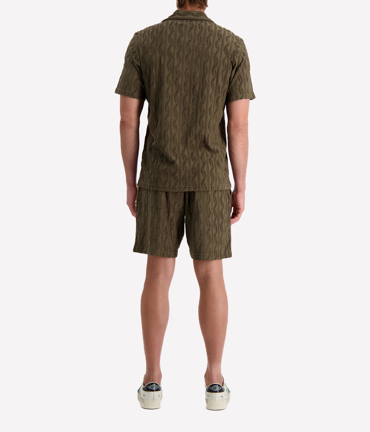 Men's Faustino Polo in organic Terry cotton with jacquard pattern, featuring an open camp collar, relaxed fit, and side slits.