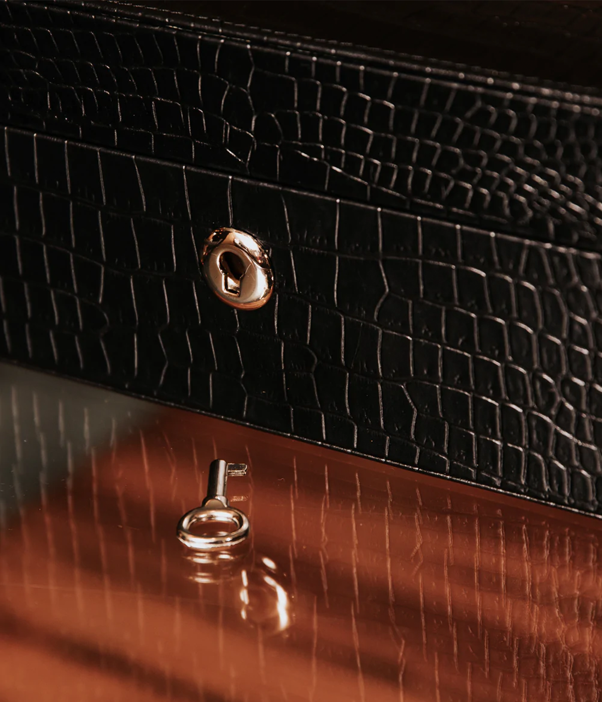 Side view of the Brompton 5-piece watch box in black leather, highlighting the gold lock and key. The elegant box is lined with premium suede for added protection and sophistication.