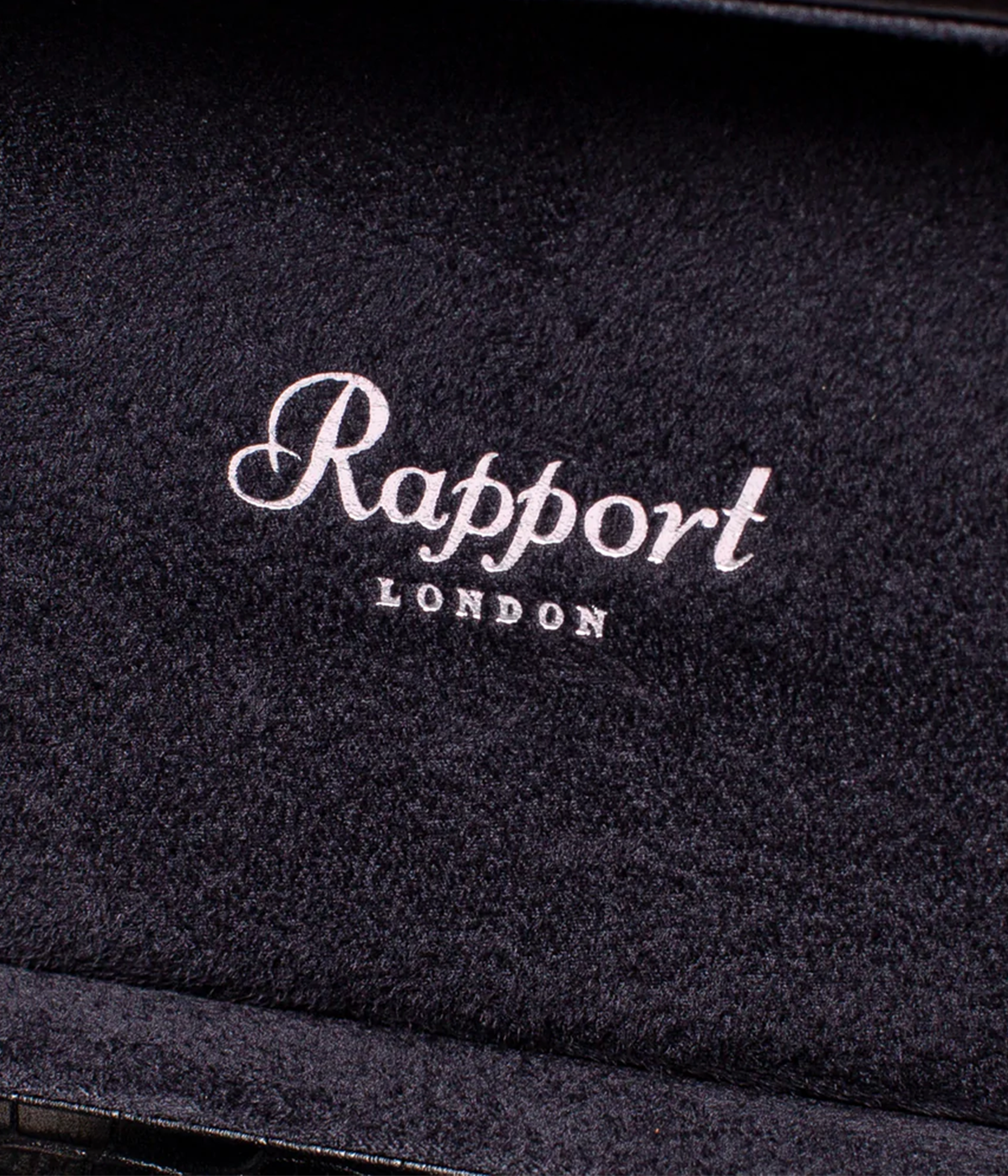 Close-up of the black crocodile-effect leather exterior of the Brompton 5-piece watch box, showcasing its sleek texture and gold detailing. A stylish, secure storage solution for your watches.