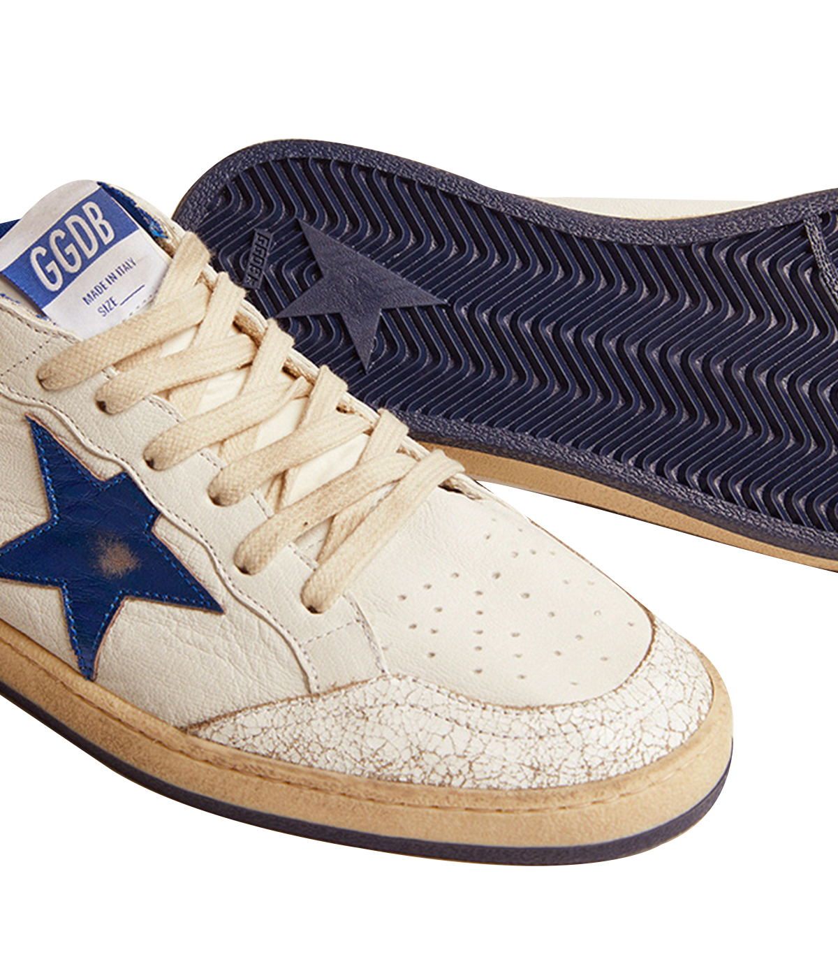 Golden Goose Ball Star sneakers channel an '80s American college and basketball vibe. Crafted in white nappa leather, they feature a metallic navy leather star and heel tab, along with white crackle-leather inserts. The sneakers are completed with white laces, giving them a vintage-inspired look with modern appeal.