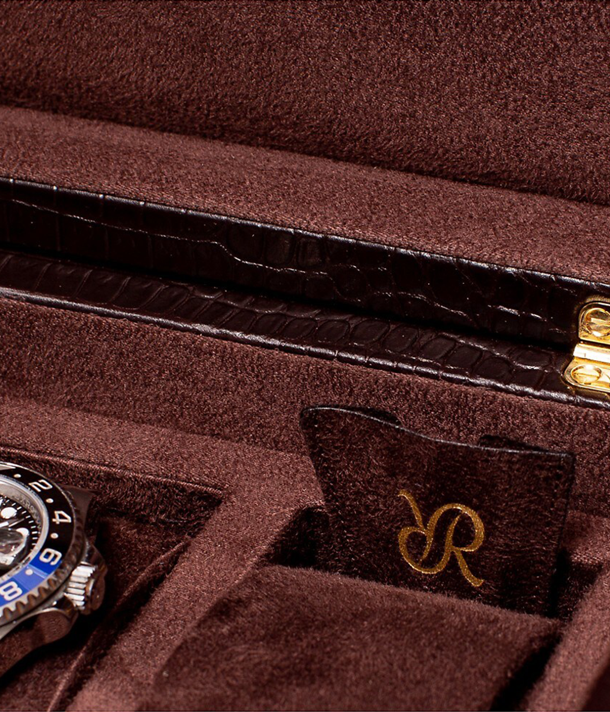 Close-up of the crocodile-effect leather exterior of the Brompton 5-piece watch box, showcasing its rich texture and gold fitments. A stylish and functional storage solution for your watches.