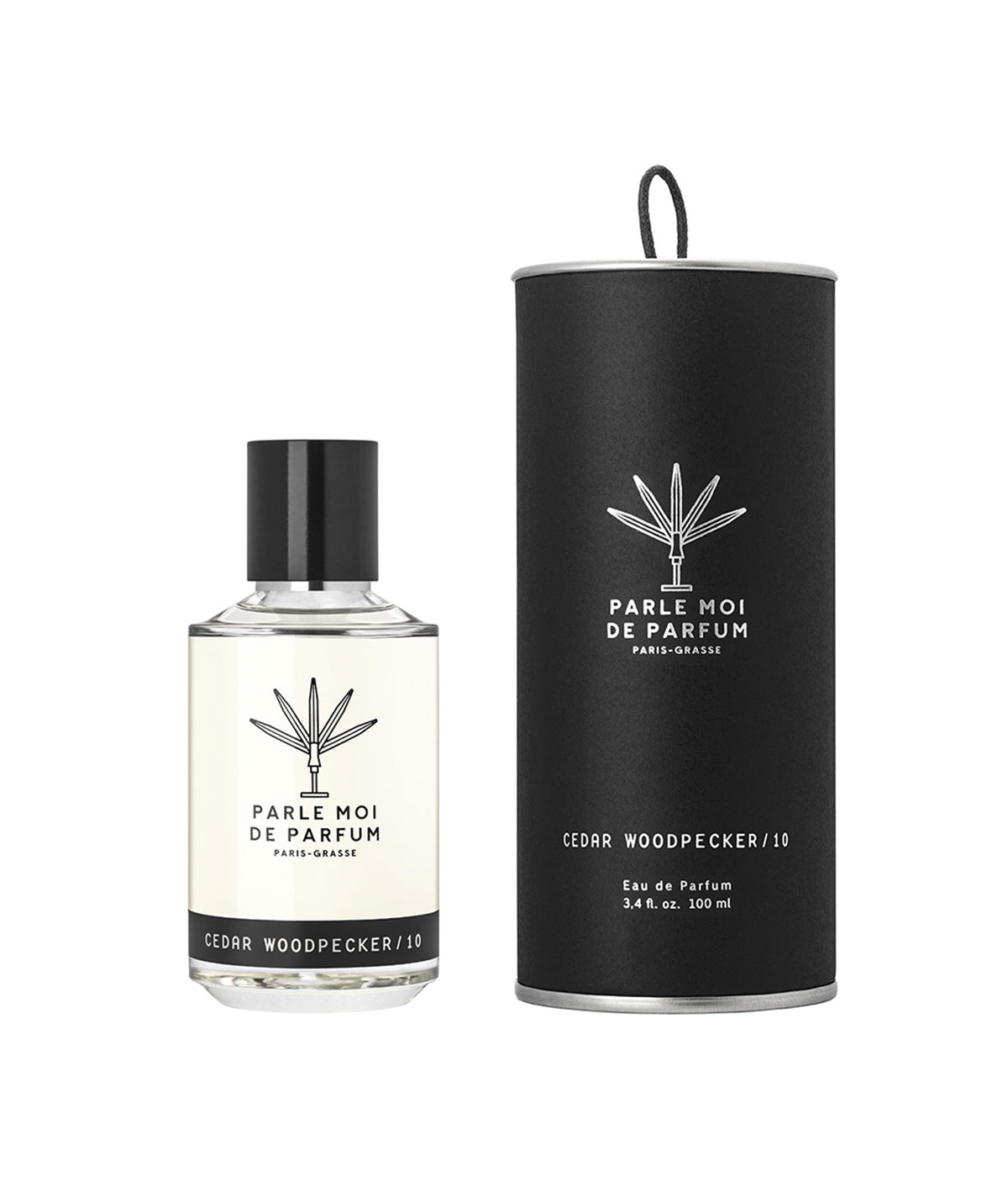 Parle Moi Cedar Woodpecker perfume bottle placed next to its matching box, showcasing the clean, elegant packaging.