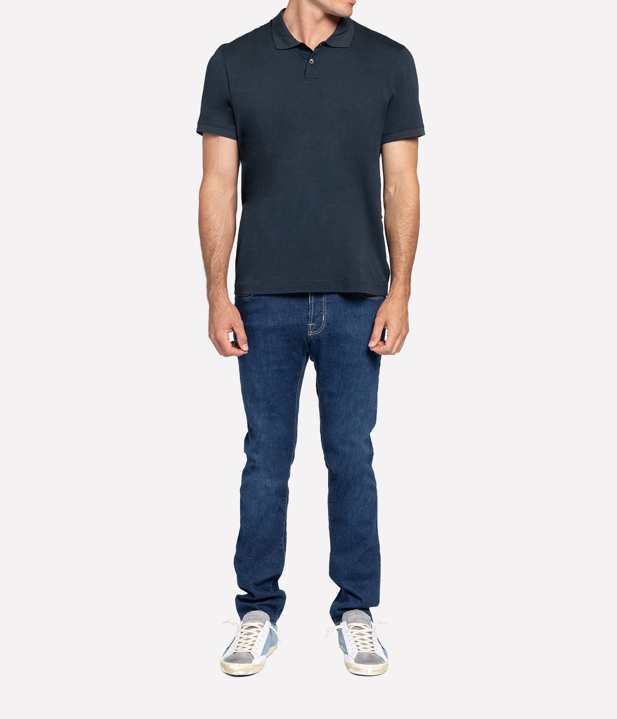 Model wearing the James Perse Luxe Lotus Jersey Polo, showcasing the classic collar, short sleeves, and clean, straight hem. The smooth, elevated jersey fabric drapes effortlessly, offering a polished yet comfortable look perfect for casual or smart styling.