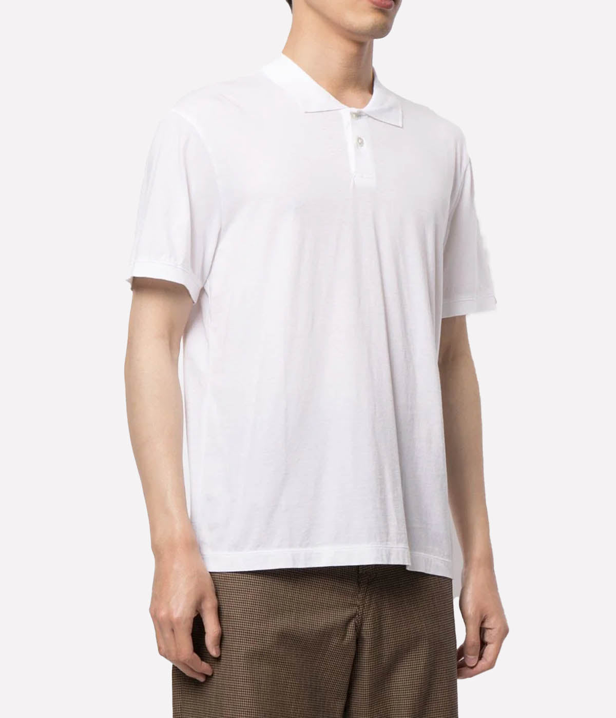 Model wearing the James Perse Luxe Lotus Jersey Polo, showcasing the classic collar, short sleeves, and clean, straight hem. The smooth, elevated jersey fabric drapes effortlessly, offering a polished yet comfortable look perfect for casual or smart styling.