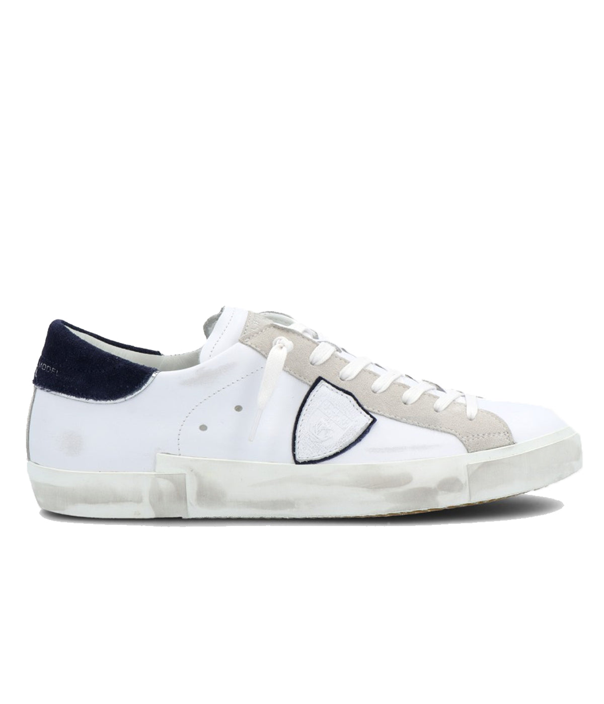 Side view of Philippe Model PRSX Low Man sneakers showcasing the unique vintage-effect design, with a patented foxing tape creating an imperfect sole. The shield on the side features the City of Paris coat of arms. The upper is crafted from high-quality Italian calfskin and suede, with laminated suede inserts.