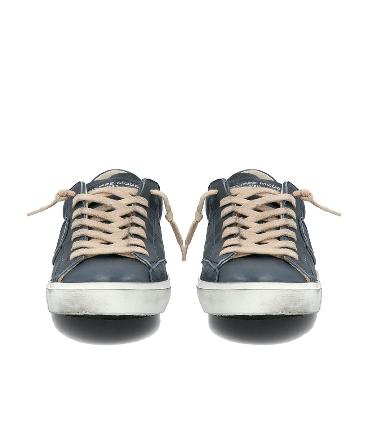 Front view of Philippe Model PRSX Low Man sneakers, showcasing the worn-effect white screen-printed laces and the vintage-used effect on the calfskin and suede upper. The unique design features a patented foxing tape, creating a purposefully imperfect sole. The sleek silhouette exudes a refined yet casual style.