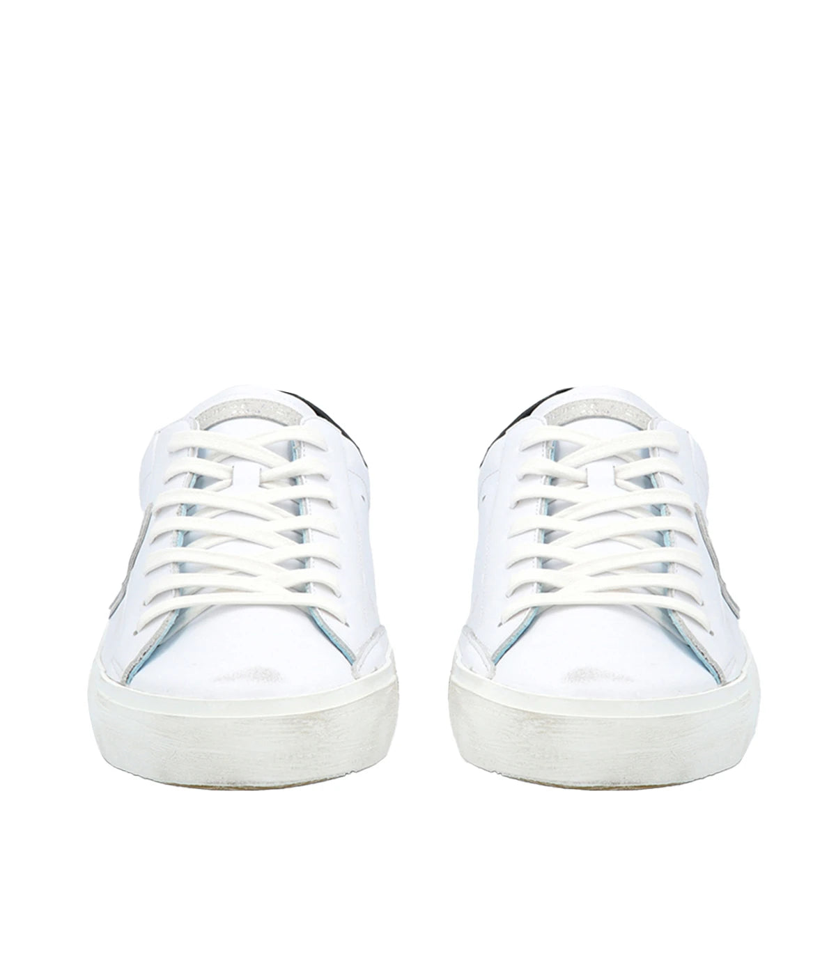 Front view of Philippe Model PRSX Low Man sneakers, showcasing the worn-effect white screen-printed laces and the vintage-used effect on the calfskin and suede upper. The unique design features a patented foxing tape, creating a purposefully imperfect sole. The sleek silhouette exudes a refined yet casual style.